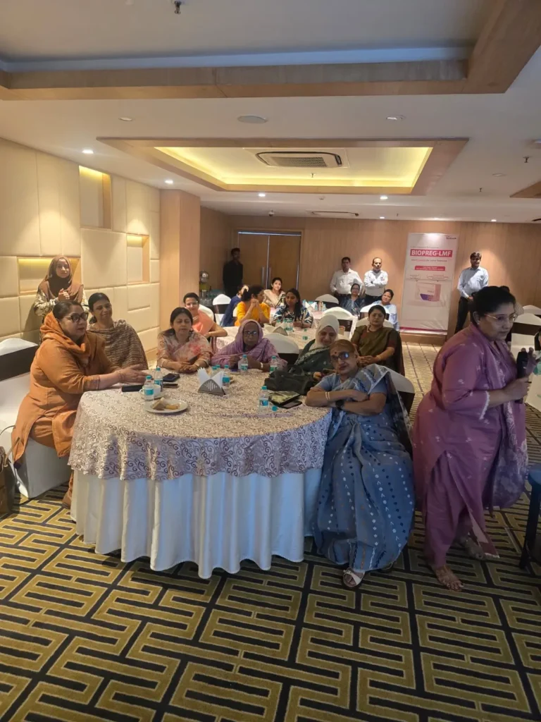 Participants attending a women's health awareness seminar seated in a conference hall during an interactive healthcare education session.